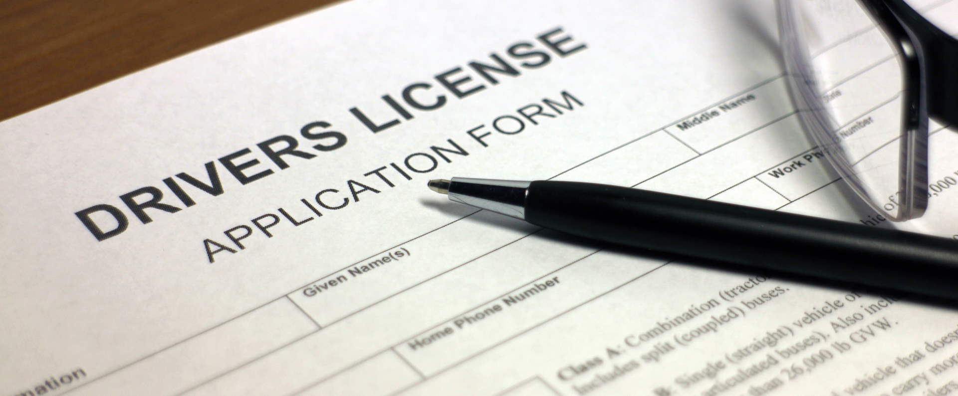 Pen laying across driver's license application form